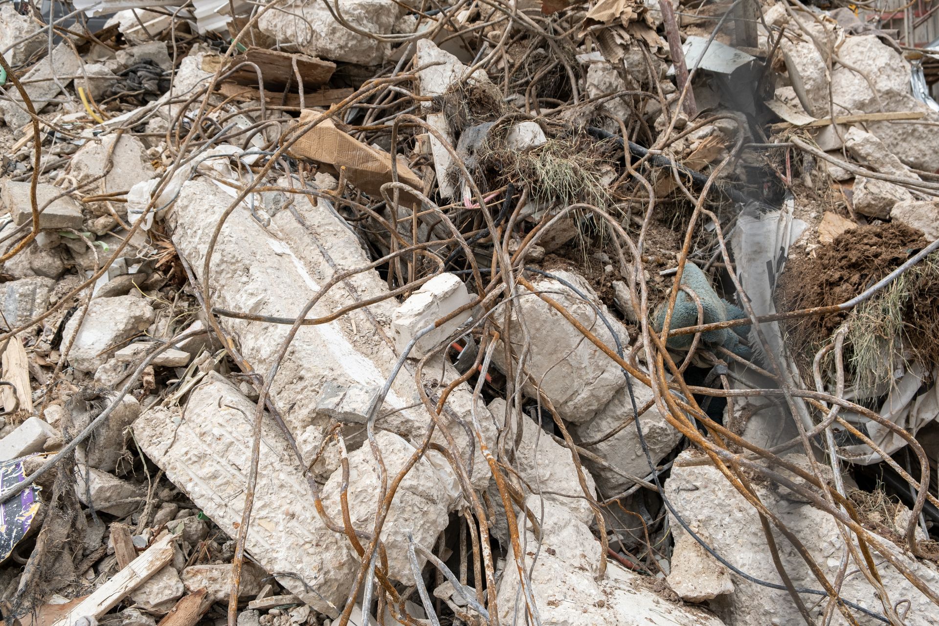 A pile of rubble and branches laying on the ground.