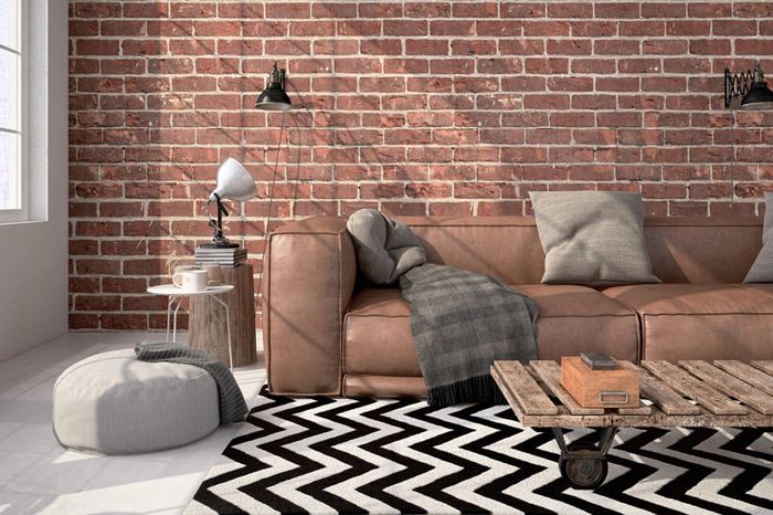 furnished living room with brick wall