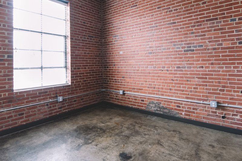 Empty room with rustic red brick wall and big window