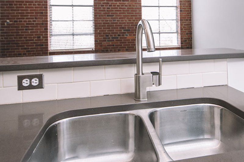 double basin stainless steel sink with power surge on counter