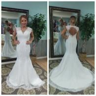 A person wearing a white, sleeveless, mermaid-style wedding dress with a lace bodice, seen from the front and back.