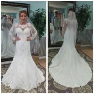 A bride wears a floor-length white lace wedding dress with long sleeves and a veil, shown from the front and back.