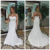 A bride in a white, strapless, lace mermaid-style wedding dress poses from the front and back in a bridal shop.