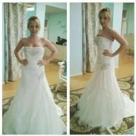 A person in a strapless white bridal gown with an embellished bodice stands in a boutique, shown from front and side views.