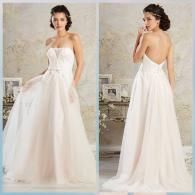 A white, strapless, A-line wedding gown with a tulle skirt, shown from the front and back against a vintage-style studio.