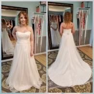 A woman tries on a strapless white wedding dress in a boutique, shown from the front and back in two mirrors.