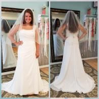 Front and back view of a woman wearing a white, floor-length strapless wedding dress and a veil in a bridal boutique.