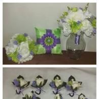 Wedding items including bouquets, a ring pillow, and boutonnieres in shades of white, lime green, and purple.