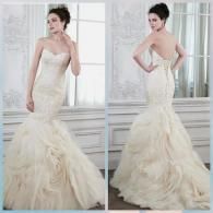 A model in a strapless, cream-colored, mermaid-style bridal gown with a ruffled skirt, shown from front and back views.