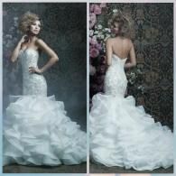 A split view of a strapless, white lace mermaid wedding dress with a ruffled, voluminous train in a dimly lit setting.