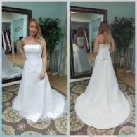 A bride standing in a shop, showing the front and back of a white, strapless, A-line wedding gown with a train.