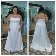 A woman wears a strapless, floor-length white wedding gown, shown from the front and back in a mirror.