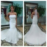 A person wearing a strapless white mermaid-style wedding gown with a lace hem, shown from the front and back in a boutique.