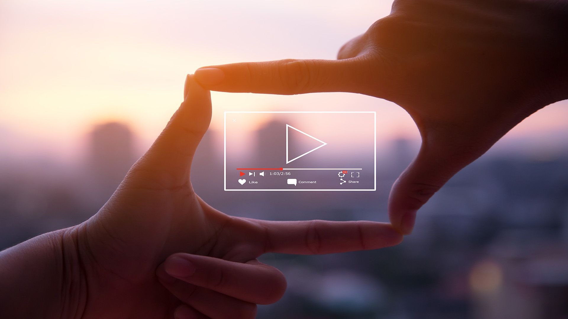 Hands framing a video player overlay with a play button against a blurred city sunset.