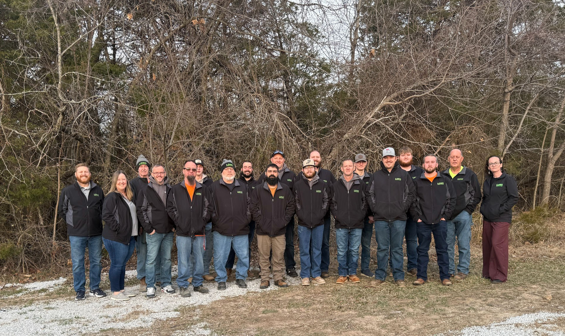 White heat pump unit outdoors, on a beige wall, sunlight.