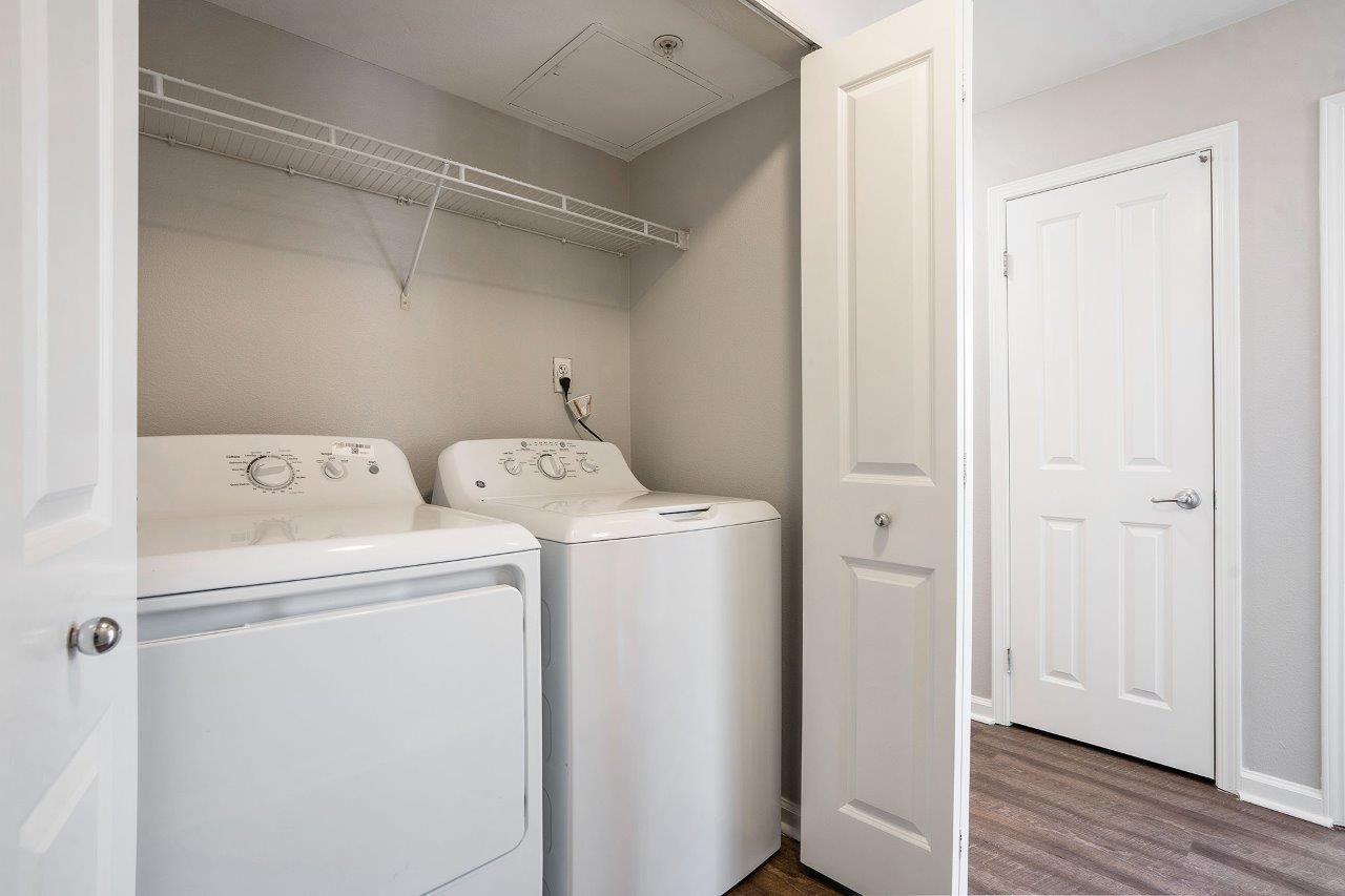 In-unit laundry closet with a washer and dryer side by side.