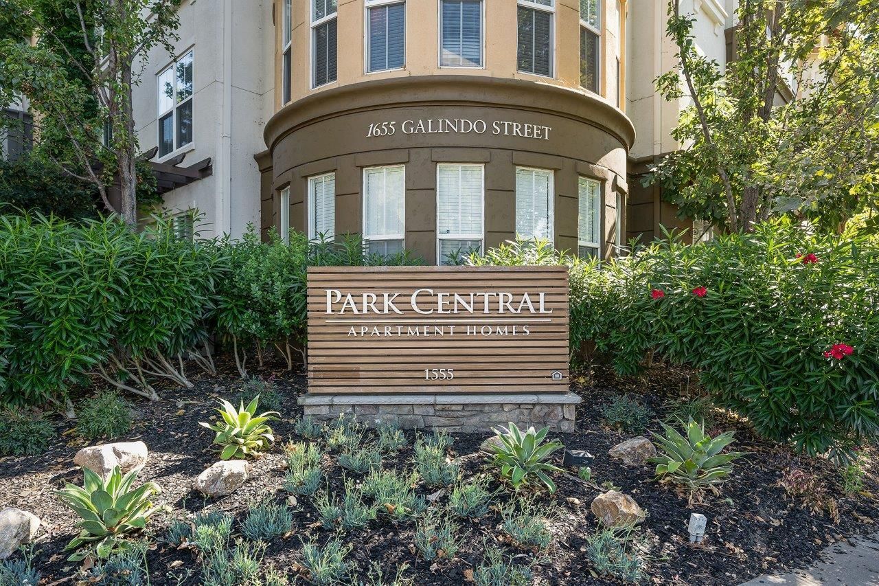 Exterior view of Park Central Apartment Homes sign with landscaping and the building frontage.