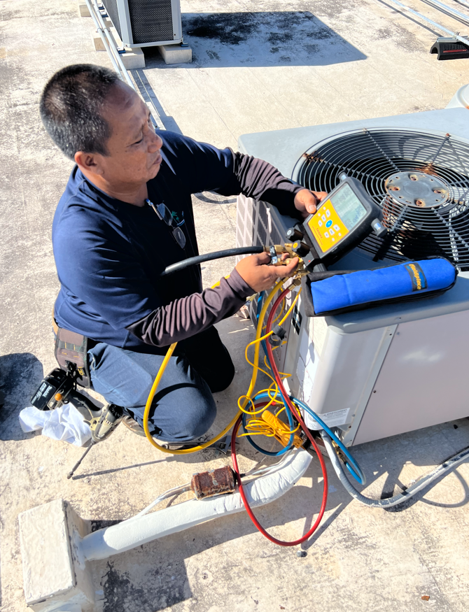 HVAC tech fixing air conditioner