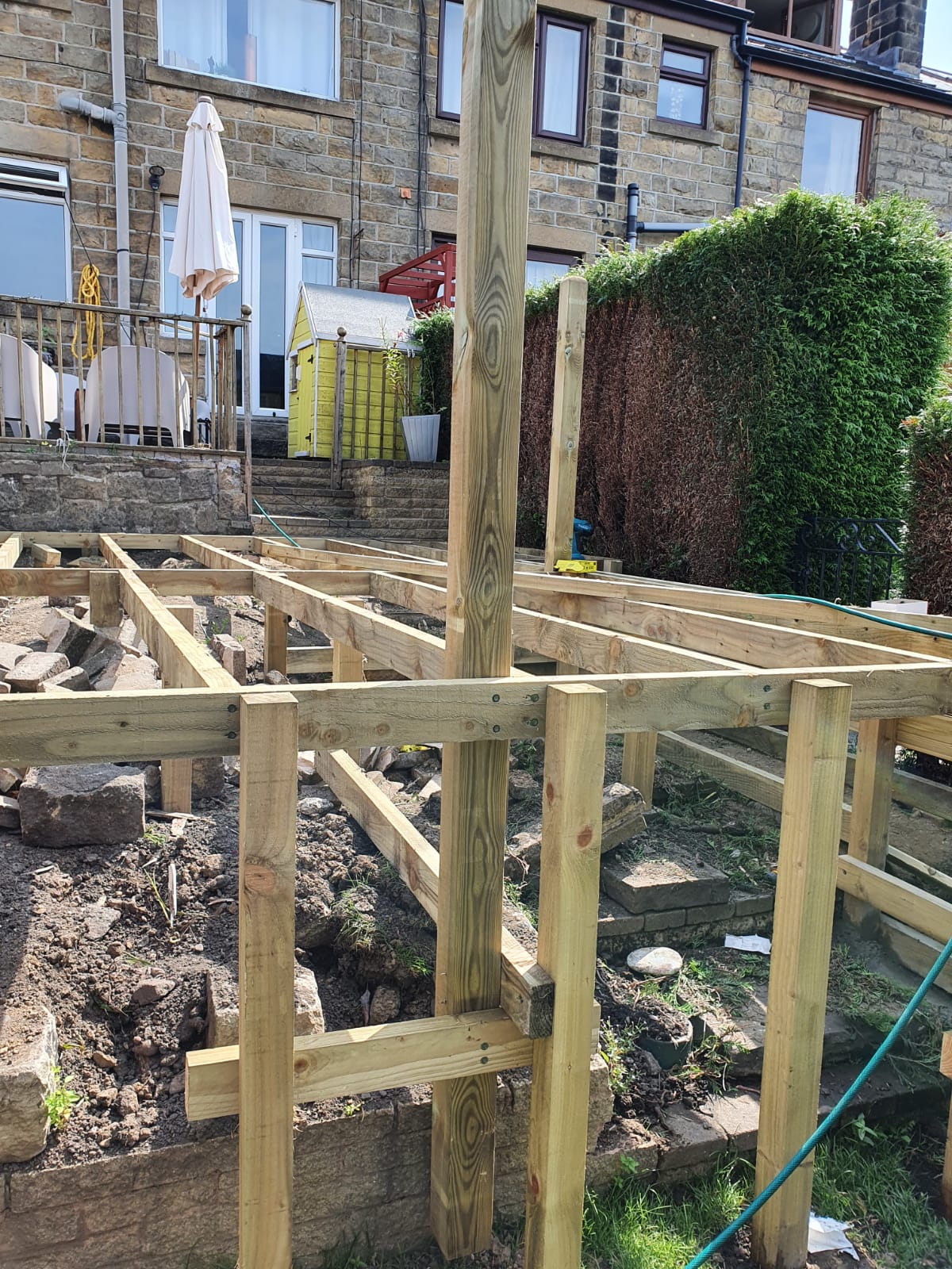 Raised wooden decking being constructed in a Cardiff back garden