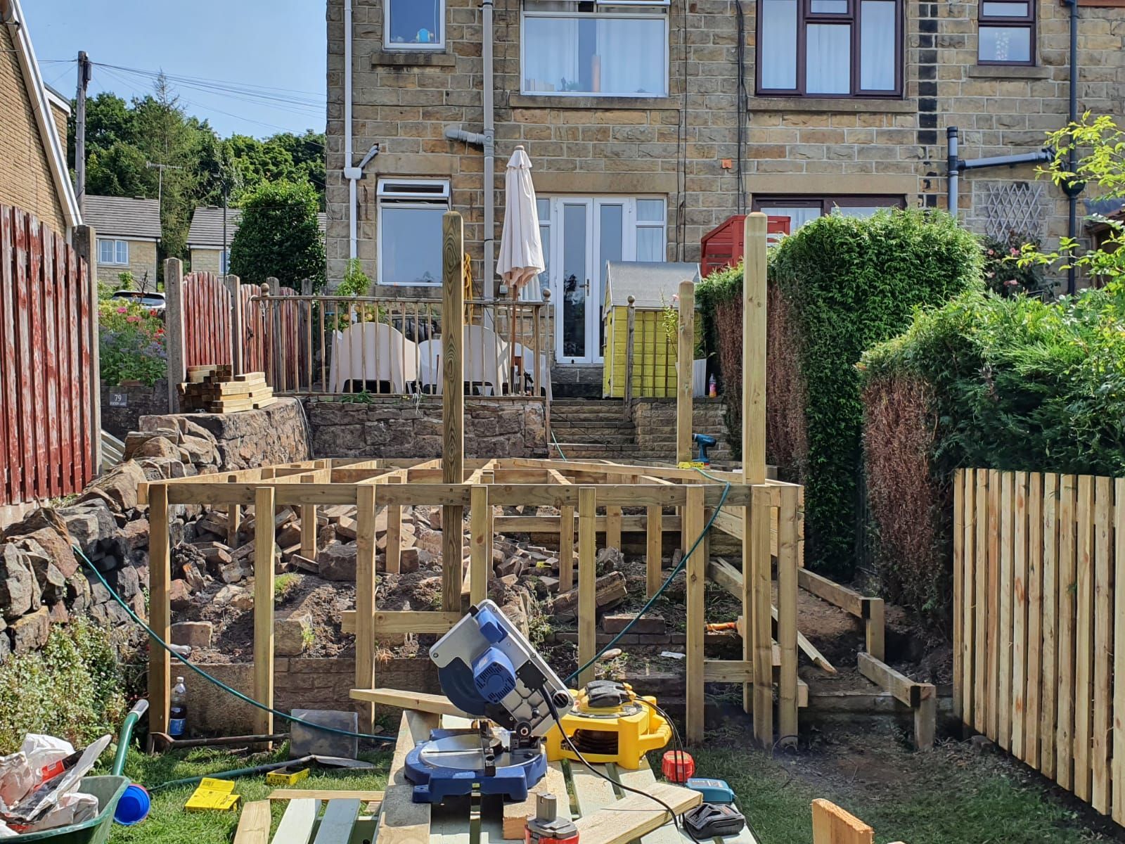 Raised wooden decking being constructed in a Barry back garden