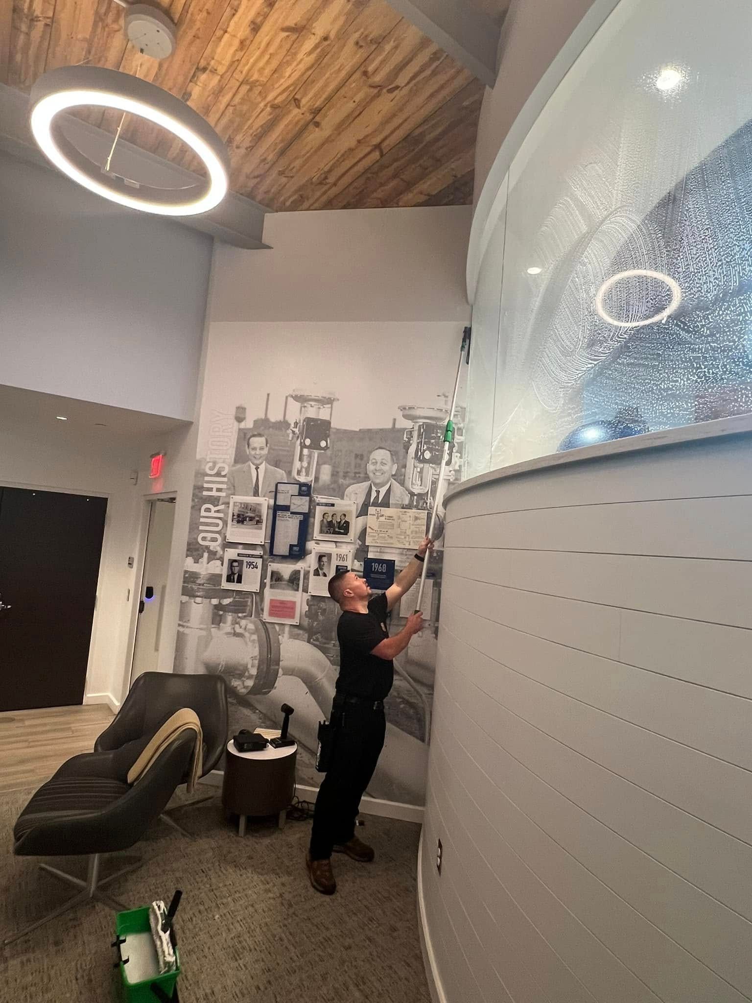 A man is standing in front of a wall with a picture on it.