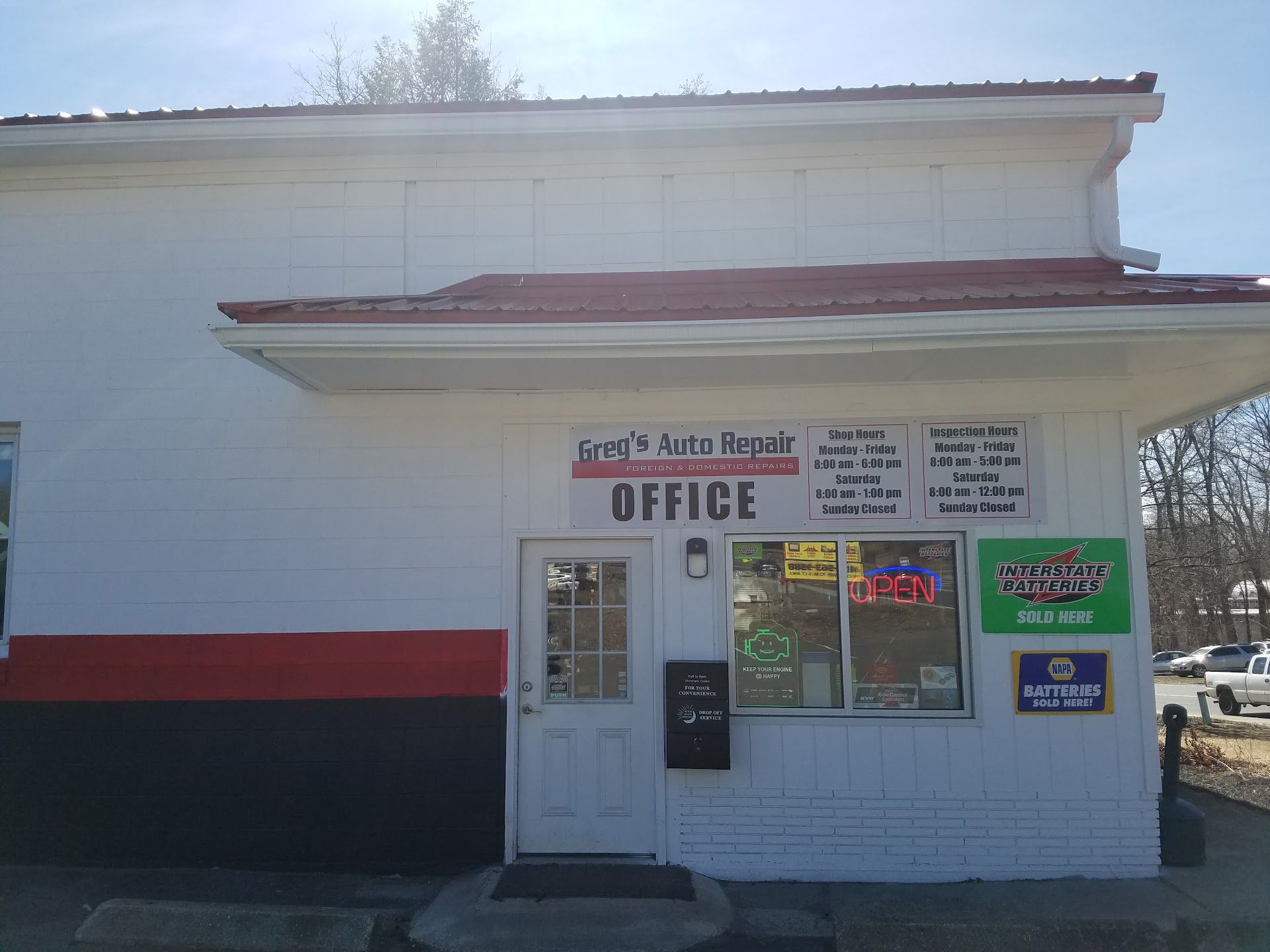 White building with red and black stripes; | Greg's Auto Repair