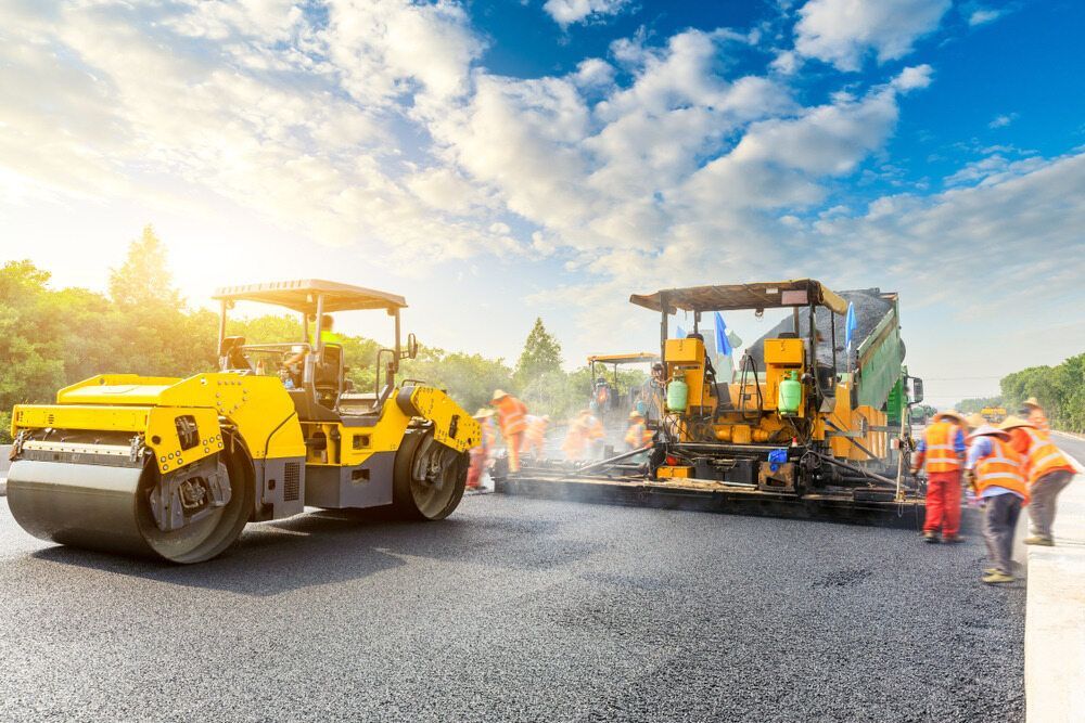 A Group of Construction Workers Are Working on a Road — Mark Hughes Earthmoving In Tenterfield, NSW