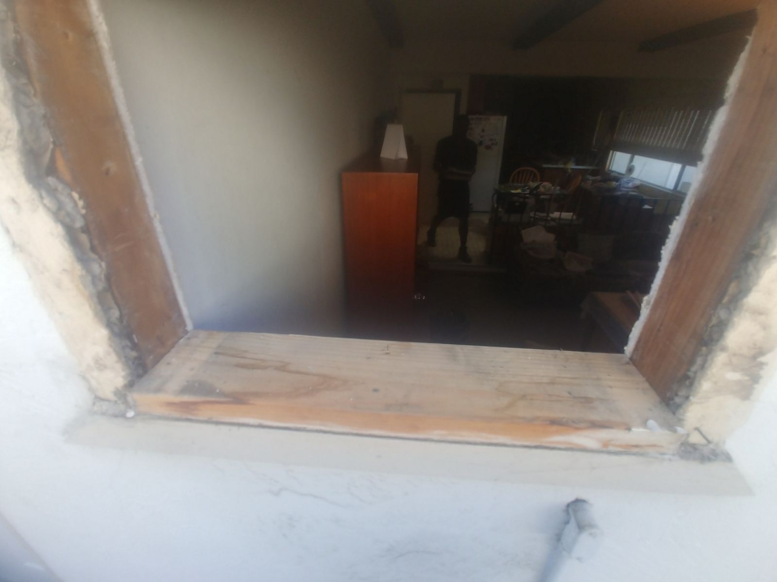 A window in a room with a wooden frame.