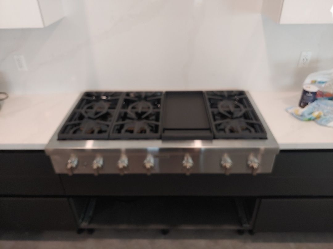 A stove with a griddle on top of it in a kitchen