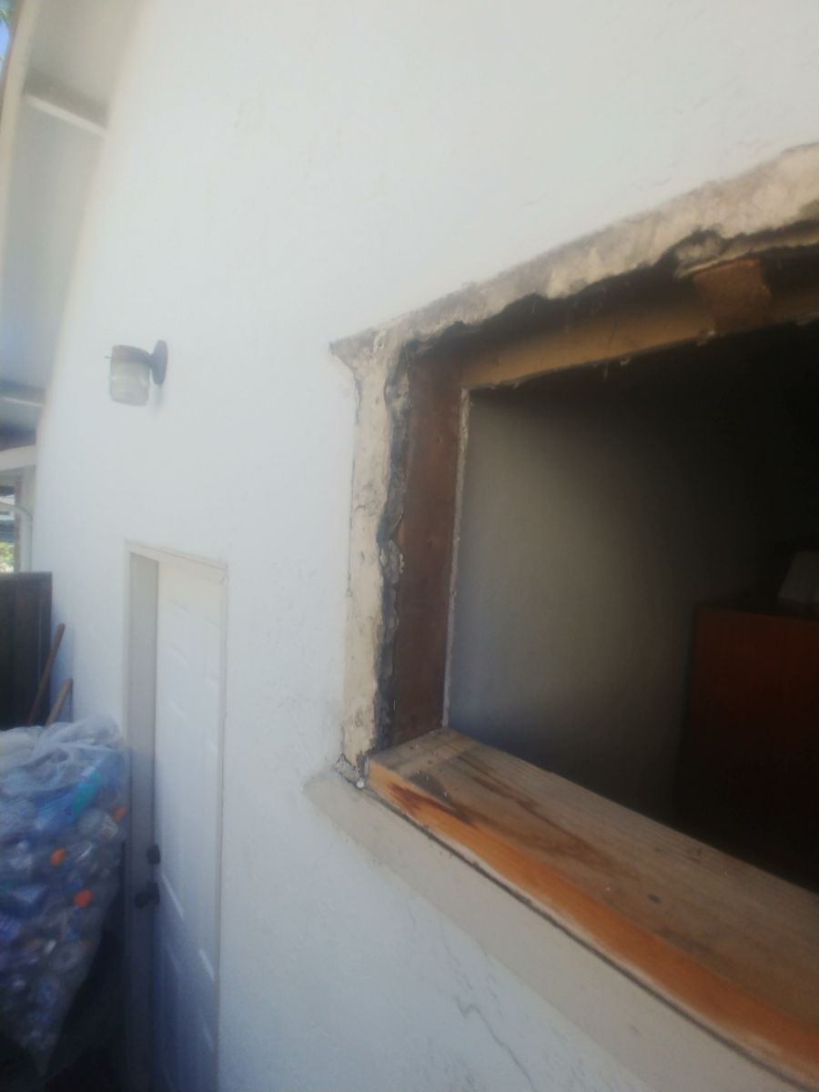 A white wall with a small window in it