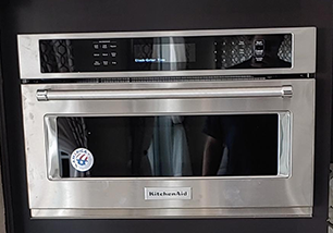 A stainless steel kitchenaid microwave oven with a glass door