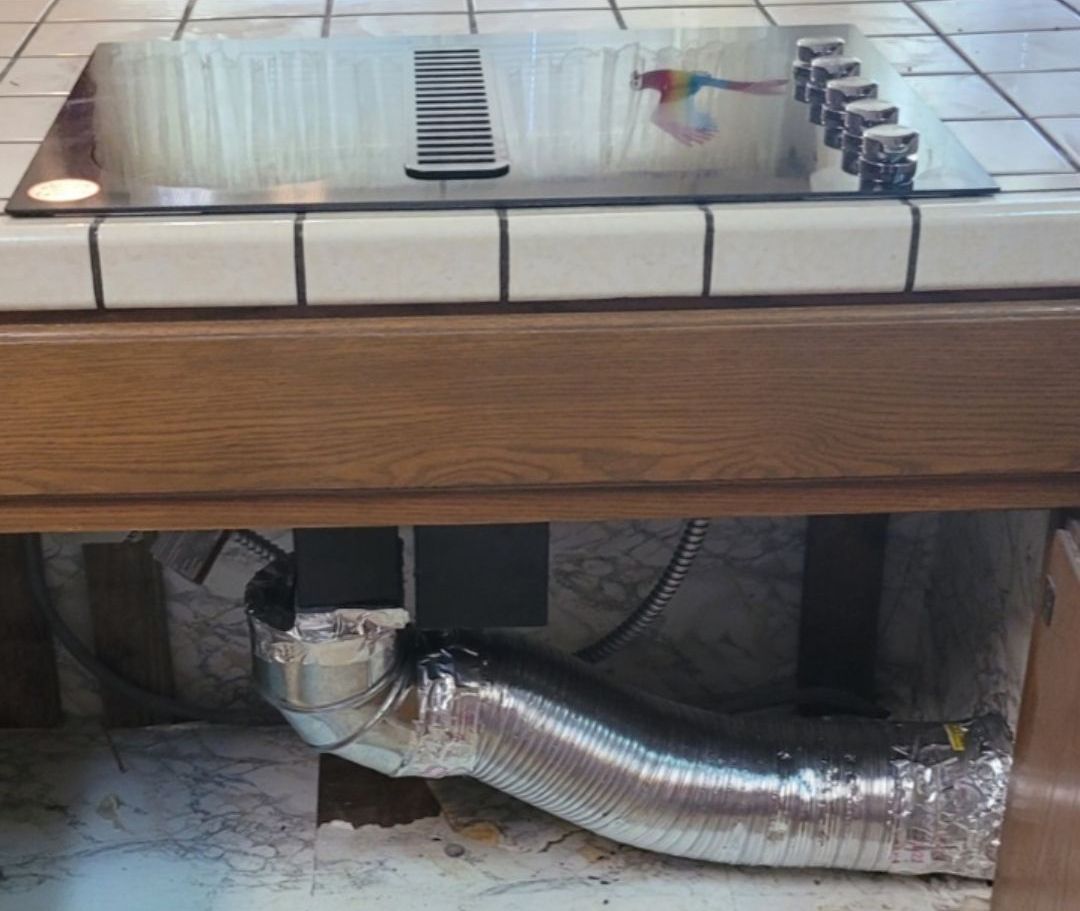 A stove top oven with a hose attached to it