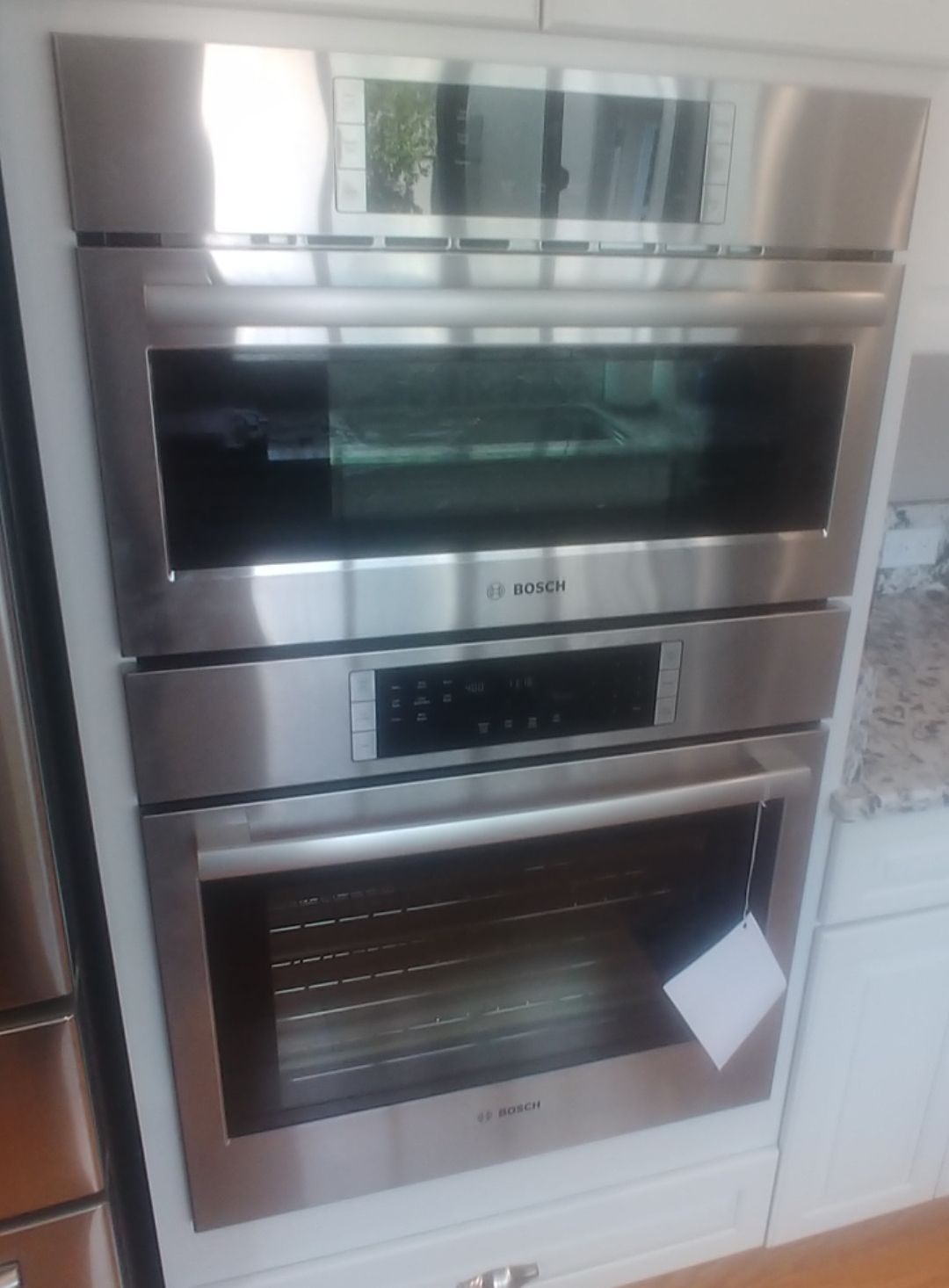 A stainless steel oven with a tag on it