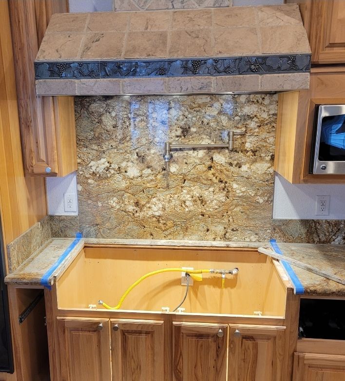 A kitchen with wooden cabinets and granite counter tops