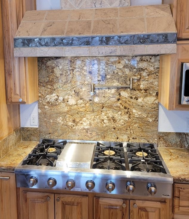 A kitchen with a stove top oven and a microwave