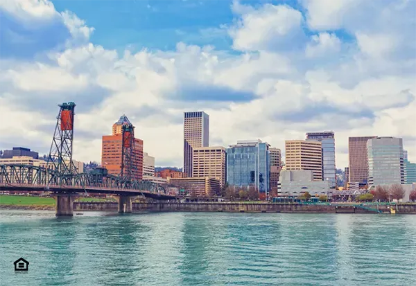 Skyline view of Portland Oregon with view of riverfront and bridge into downtown skyscraper buildings