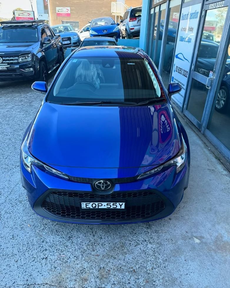 A Blue Toyota Corolla Is Parked in Front of A Building — Platinum Hand Car Wash & Detailing in Belconnen, ACT