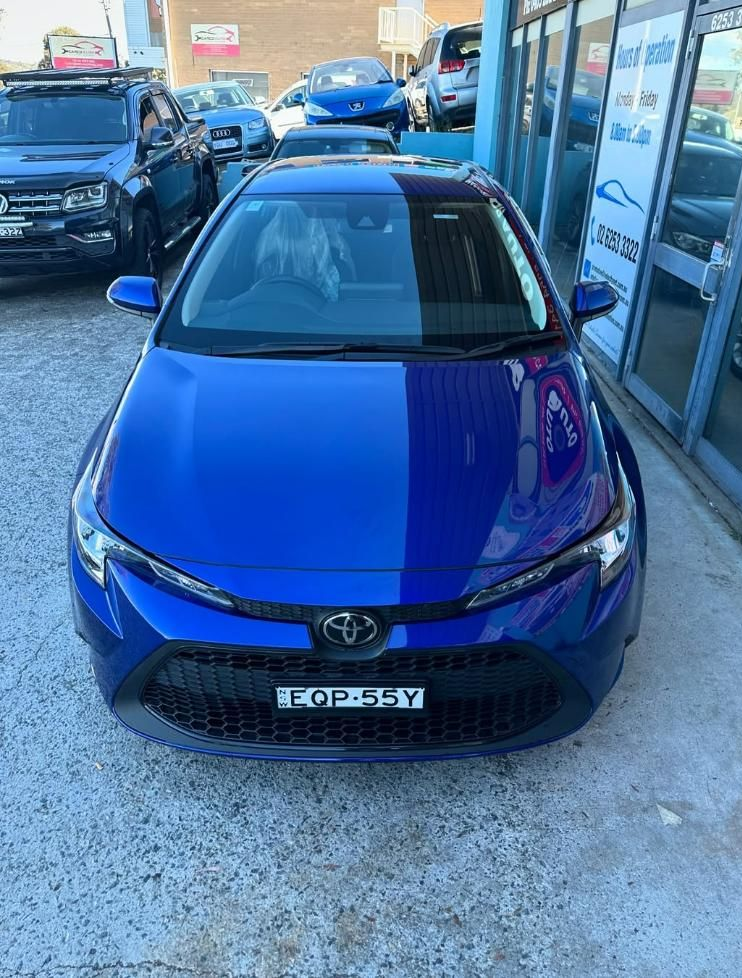 A Blue Toyota Corolla Is Parked in Front of A Building — Platinum Hand Car Wash & Detailing in Belconnen, ACT