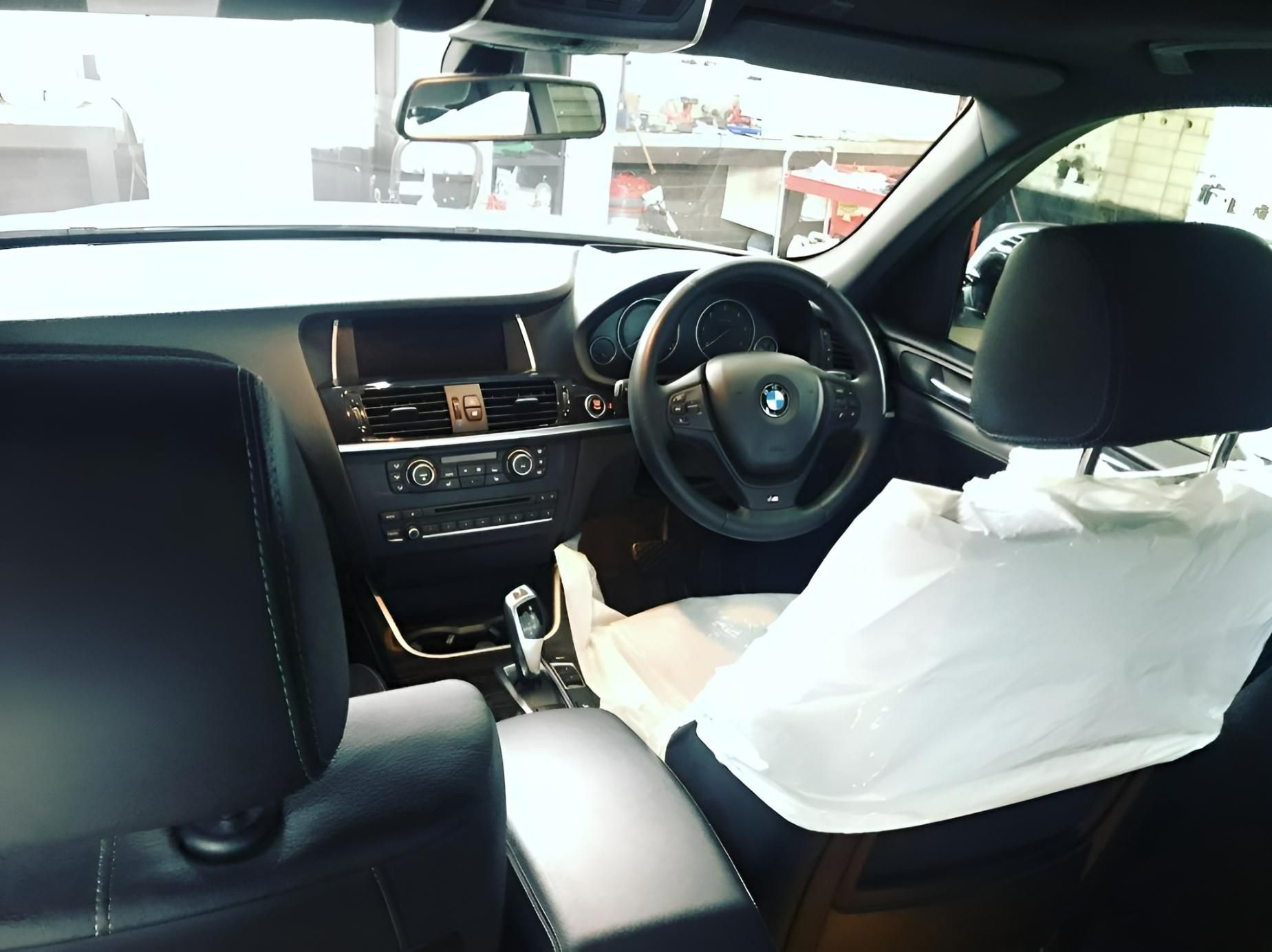 The Inside of A BMW with Airbag Covers on The Seats — Platinum Hand Car Wash & Detailing in Belconnen, ACT