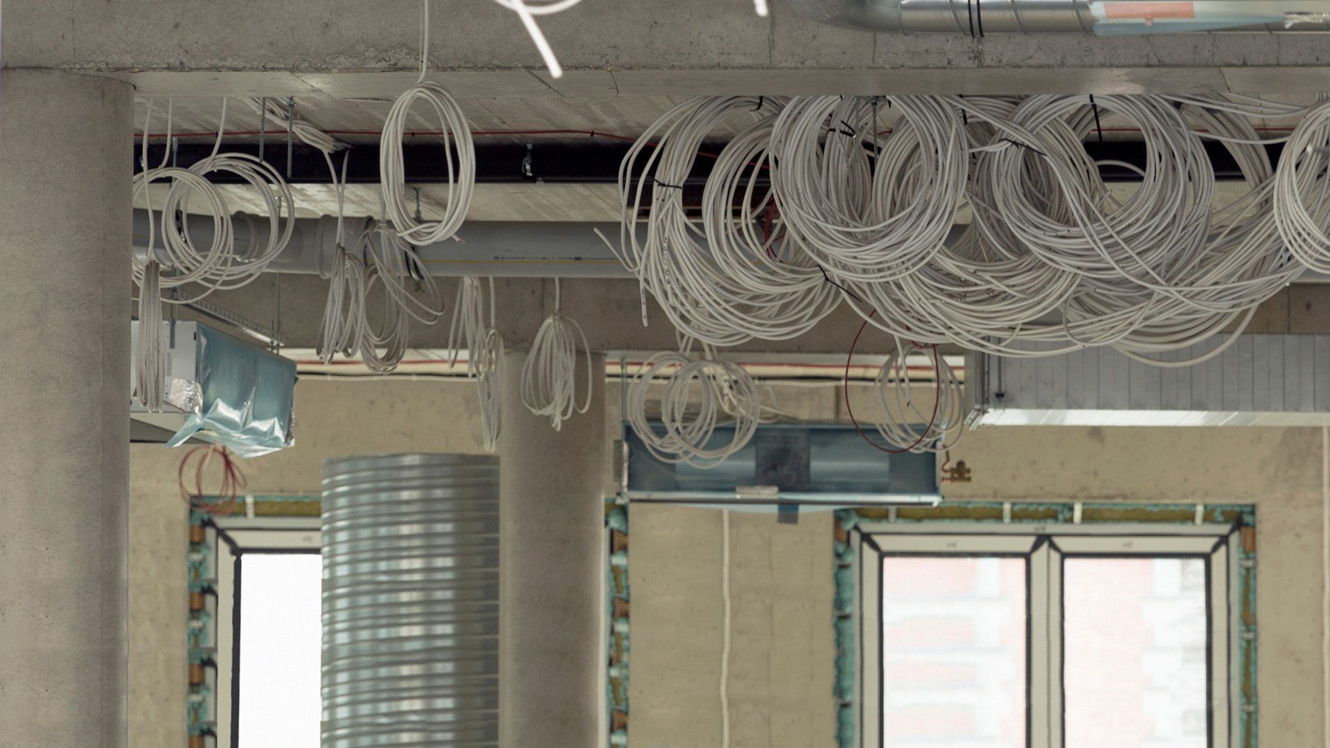 A room with a lot of wires hanging from the ceiling