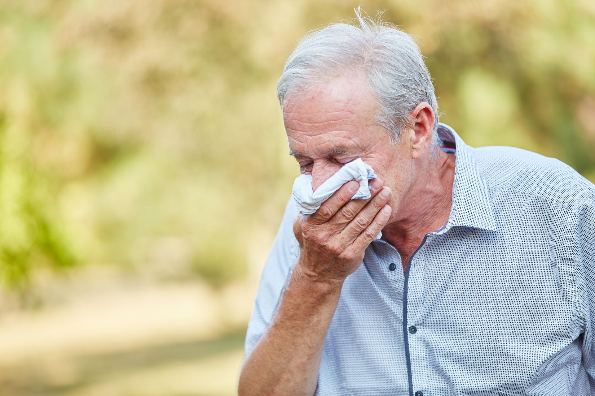 A senior citizen with spring allergies
