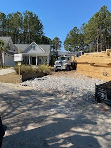 Truck And Bulldozer Beside A House — Rincon, GA — Rahn’s Services