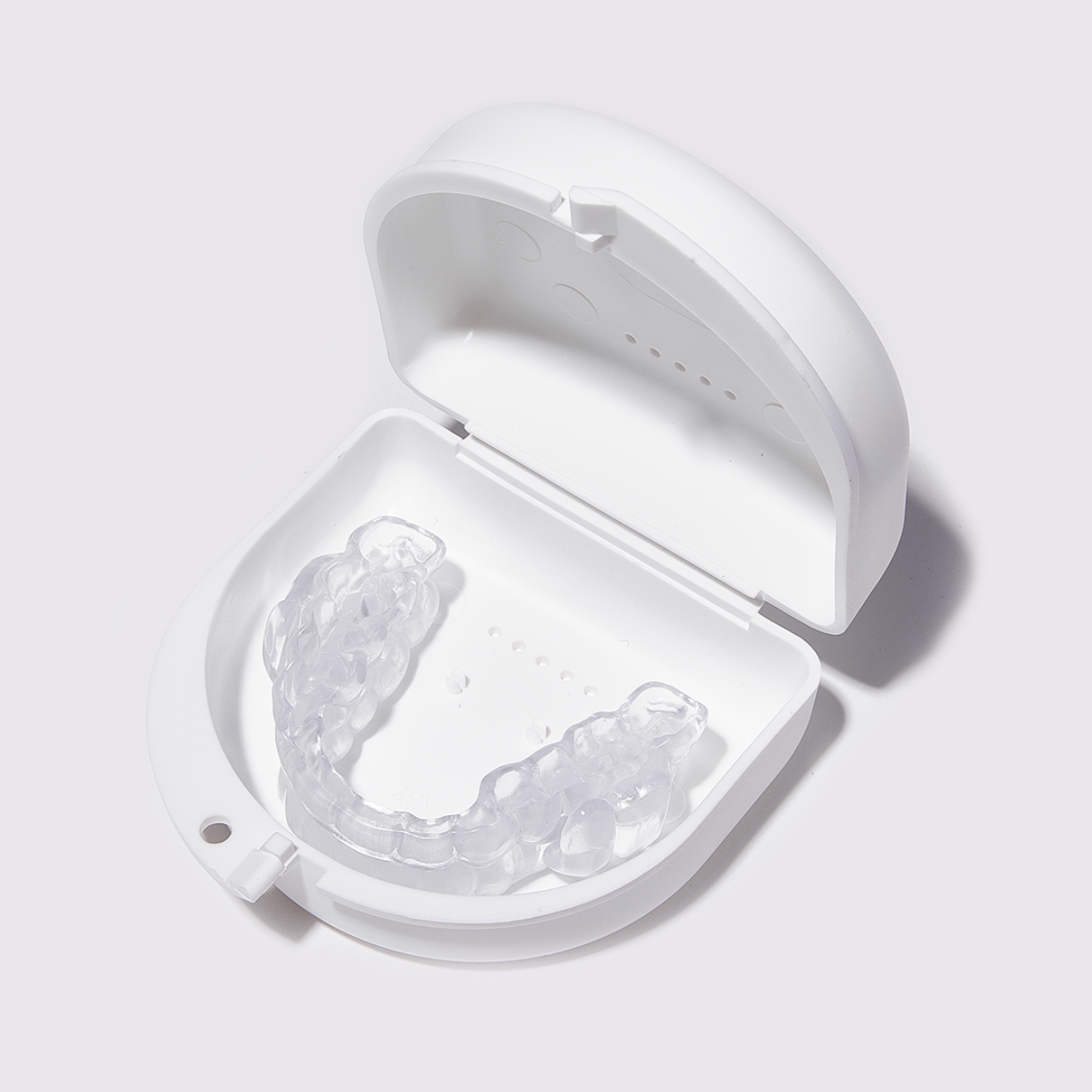 Blue, plastic dental appliance with metal connecting rods, on white cloth.