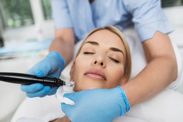 A woman is getting a facial treatment at a beauty salon.