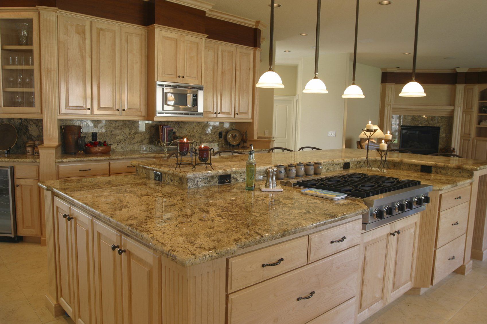 A kitchen with a large island and granite counter tops