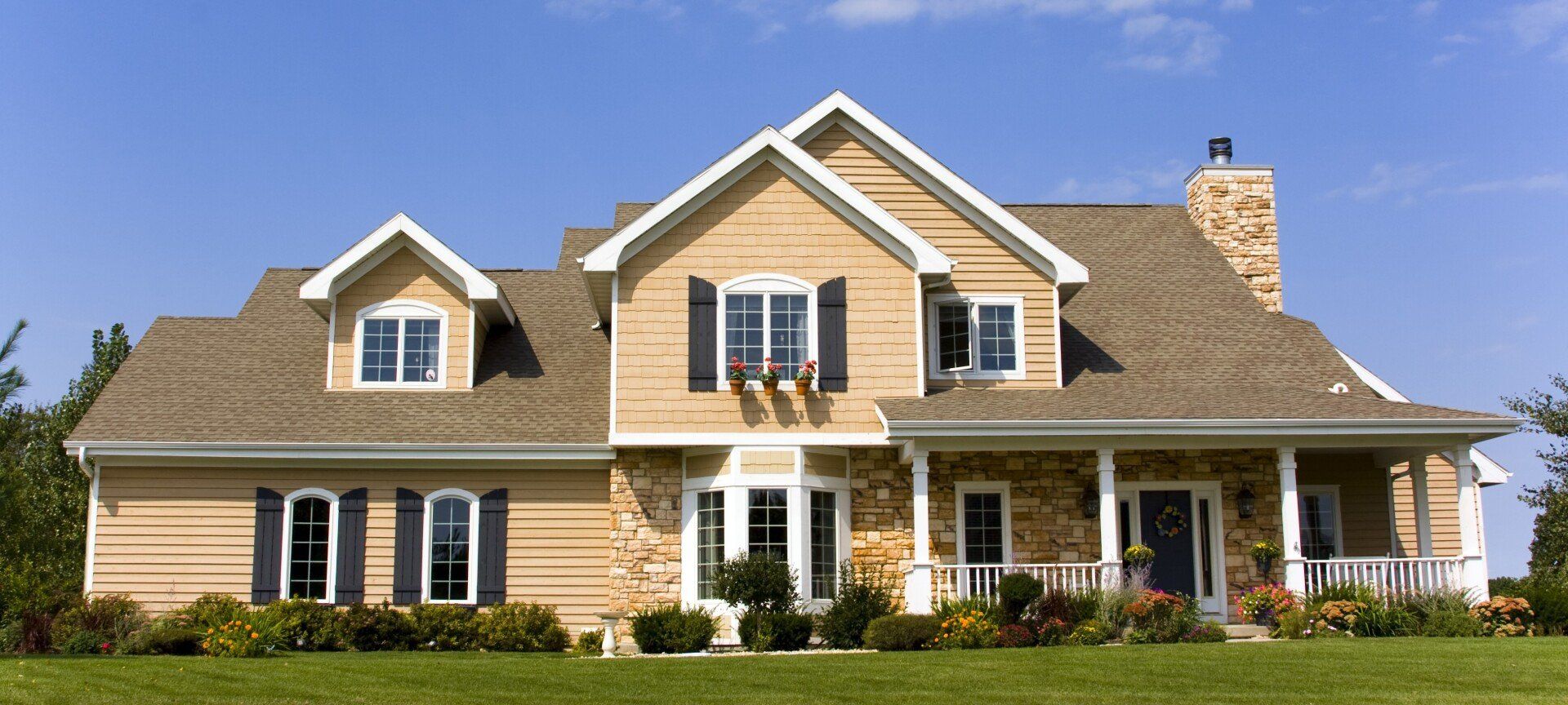 A large house with a lot of windows and shutters