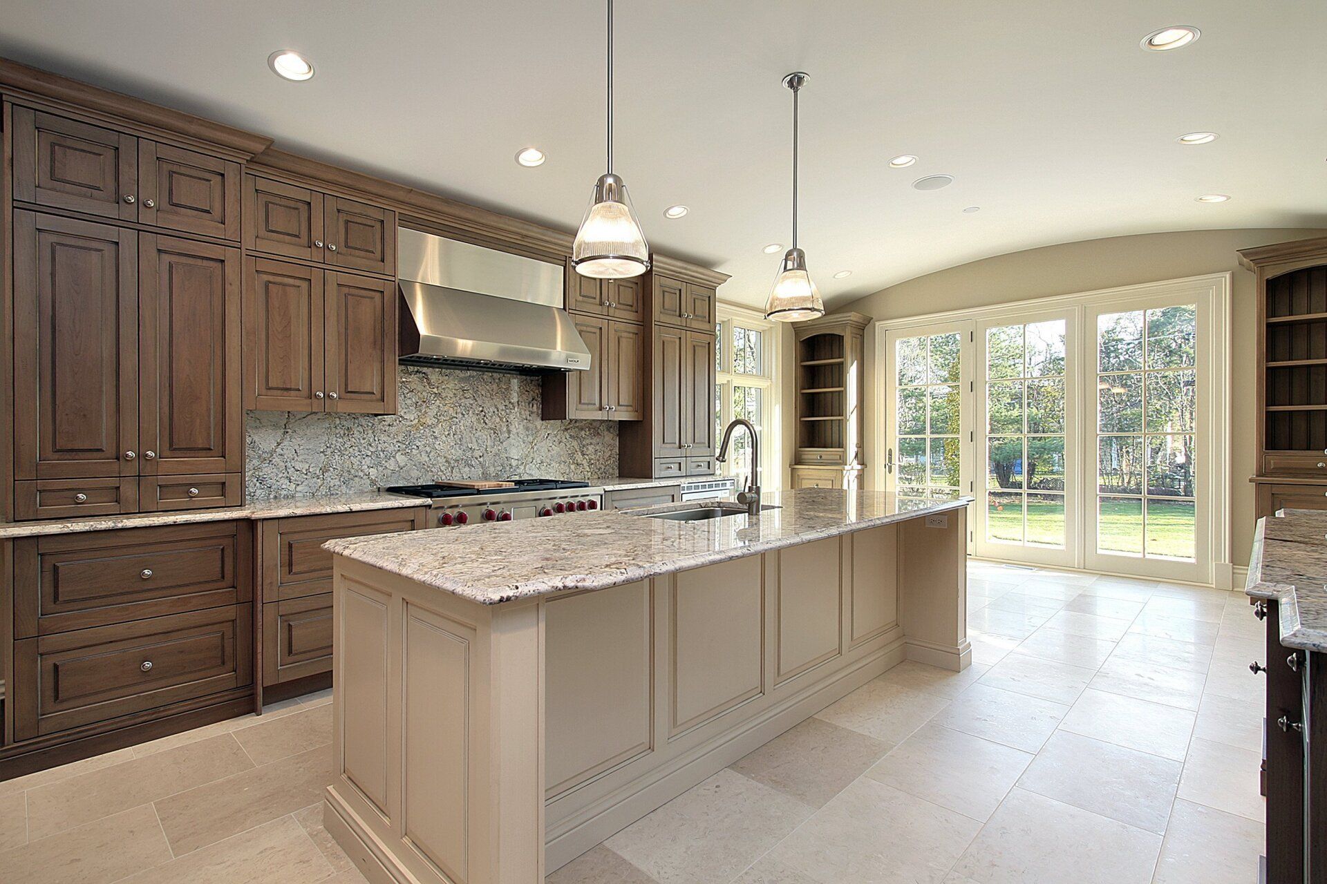 A kitchen with a large island and stainless steel appliances