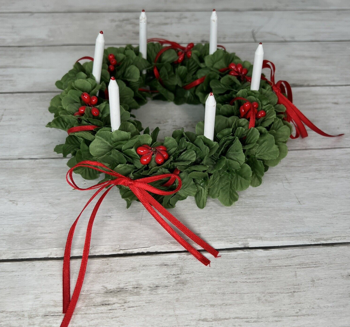 An American Girl brand Christmas wreath with red berries and white candles