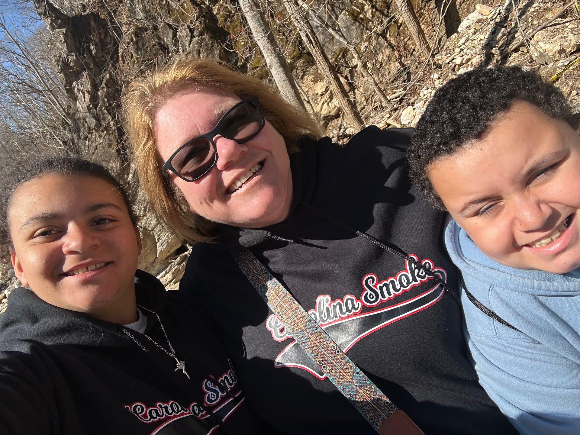 A woman and two children are posing for a picture.