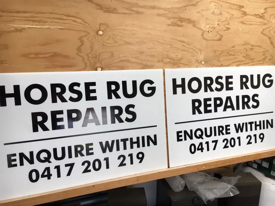A sign that says horse rug repairs on it